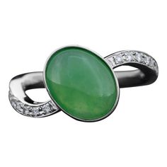 GIA certified natural grade A Fei Cui green Jade & diamond ring featuring a 3.50 carat oval shape cabochon jade accented by round brilliant cut diamonds set in 900 platinum.  Condition: Excellent to Very Good. Wear commensurate with age.  Material: 900 Platinum Gram Weight: 6.92 grams Ring Size: 7 3/4  Main Stone: Natural Jadeite Jade GIA Report No. 5231133916 Type: Grade A Dimensions: 11.60 x 9.00 x 4.01 mm Shape: Double Cabochon Color: Green Carat Weight: 3.50 carat  Accent Stones: Natural Diamonds Shape: Round Brilliant Color: G-H Average Clarity: SI-1 Average Carat Weight: 0.12 carats Jade Diamond Ring, Jadeite Ring, Green Jade, Jade Green, Round Brilliant Cut Diamond, Brilliant Colors, Round Brilliant Cut, Solitaire Ring, Type A