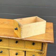 a wooden box sitting on top of a dresser