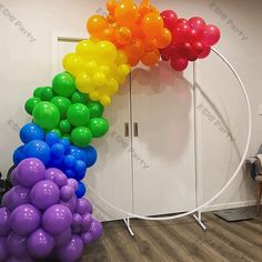 a rainbow colored balloon arch in an office