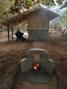 a fire pit in the middle of a forest