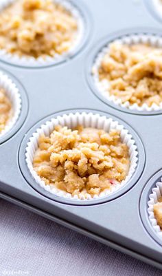 muffins with crumbs sitting in a cupcake tin