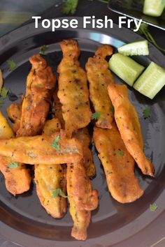 there is a plate with fried fish and cucumber slices on it, along with the words topse fish fry