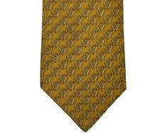 This is a vintage Gianni Versace silk necktie made probably during the 1980s.  This Gianni Versace silk necktie is woven with a GV motif pattern in tones of gold, black and white.  The tie is in very good condition with no noted wear, soiling or staining - please ignore any shadows caused by the photo lighting.  I have not had it dry cleaned, but this Gianni Versace silk necktie is clean and in very usable condition.  The content/care label states "100% Silk" while the tie loop reads "Gianni Versace Made in Italy".  This tie measures 59 1/2" in length and has a width of 4" at its widest.  This is a very rich looking tie - nice addition to a Versace collection! Gold Silk Tie For Formal Occasions, Gold Silk Formal Tie, Scarf Versace, Versace Tie, Luxury Vintage Men's Ties, Versace Collection, Gold Silk, Silk Necktie, Photo Lighting