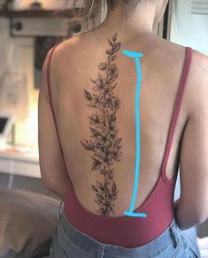 the back of a woman's neck with flowers on it and an arrow pointing up