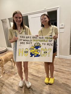 two girls holding up a sign that says, you are one in a minion