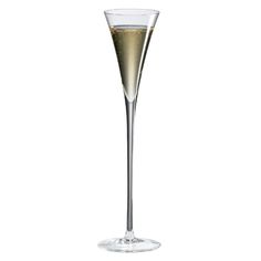 a tall glass filled with champagne sitting on top of a table