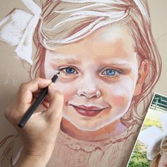 a child's face is drawn on a piece of paper with colored pencils