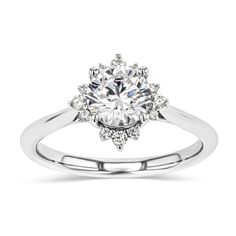 The Aura Engagement Ring features a star-shape halo of Lab Grown Diamonds on a plain metal band and set with the center stone of your choice. This ring can sit flush with any straight wedding band without taking up too much room on the finger. | We recommend stacking multiple bands on either side of this ring! | Metal Weight: 4.0gr. Avg. Band Width: 2mm. Side Stones: 0.13ct. White Gold Halo Promise Ring, Promise Halo Ring With Round Band, White Round Band Halo Ring, Promise Halo Ring In Diamond White, Cluster Ring With Halo Setting For Promise, Promise Halo Ring With Round Cut, Promise Cluster Ring With Halo Setting And Round Band, Dazzling Halo Ring For Promise, Dazzling Halo Ring For Promise Occasion