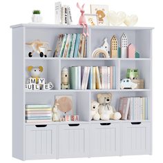 a white bookcase filled with lots of books next to stuffed animals and other toys