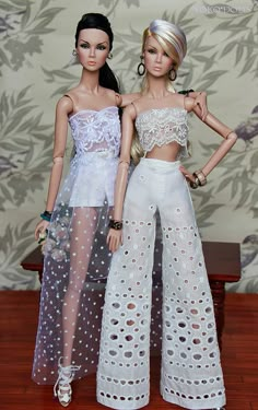 two dolls are standing next to each other