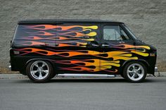 a black van with flames painted on it's side