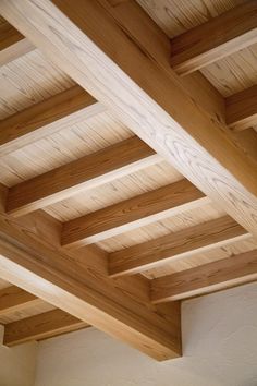 an unfinished wooden ceiling in a room