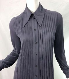 For Sale on 1stDibs - MARC JACOBS for BERGDORF GOODMAN early 2000s 1920s flapper style grey shirt dress ! Features a pleated bodice with a drop waist. Buttons up the front and Fitted Pleated Tops For Work, Fitted Pintuck Tops For Workwear, Fitted Classic Pleated Tops, Gray Fitted Formal Tops, Elegant Fitted Tops With Pintucks, Gray Fitted Top For Formal Occasions, Classic Fitted Tops With Pintucks, Vintage Fitted Tops For Semi-formal Occasions, Fitted Vintage Tops For Semi-formal Occasions