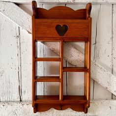 a small wooden shelf with a heart on it