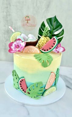 a cake decorated with fruit and leaves on a plate