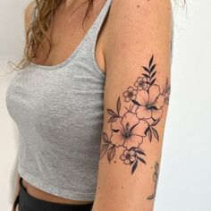 a woman with a flower tattoo on her arm