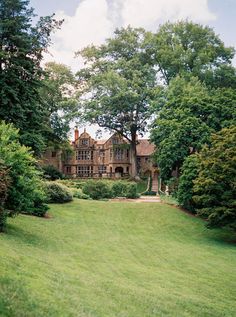 a large house surrounded by lush green trees