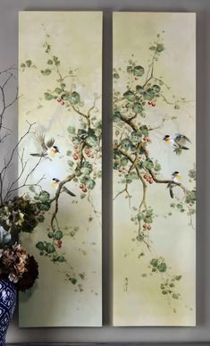 two paintings with birds on them are next to a vase filled with flowers and berries