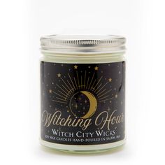 a candle with the words witch city wicks written in gold and black on it