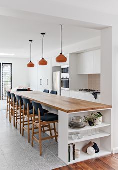 a kitchen with an island and several chairs