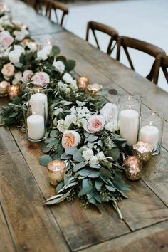 a long table with candles and flowers on it