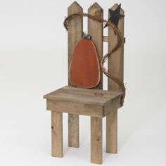 an old wooden chair with a red cushion on it's back and rope wrapped around the seat