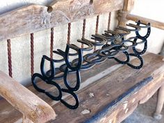 a wooden bench with several pairs of eyeglasses sitting on it's back