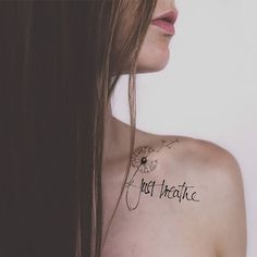 a woman with a tattoo that says just theatre on her chest and the words just theatre written in cursive ink