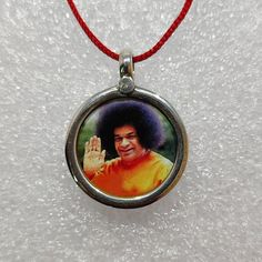 Handmade 92.5 Sterling Silver The  Great Sant of India Blessing Satya Sai Baba Spiritual Photo Print Glass Framed Pendant With Black And Colour String.   Made by My Shop Members.  Primary Colour Is Silver  Pendant Length With Loop 2.4 cm. Pendant Width 2cm. Pendant Weight 2.5 gms.   Handmade Glass Framed Photo Print Necklace Covered By 92.5 Sterling Silver. We Accept Customers Order Work, In Quantity Or A Single Pc. Also. We Makes Colour Photo Print Pendants,As Per Customers  Choice, Shape Size Adjustable Necklace For Blessings And Festivals, Adjustable Necklaces For Blessings And Festivals, Adjustable Pendant Necklace For Puja, Satya Sai Baba, Small Pendant Necklace, Spiritual Photos, Religious Photos, Handmade Pendant Necklace, Sai Baba