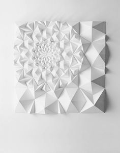 two pictures with different shapes and sizes of paper on the wall, one is made out of