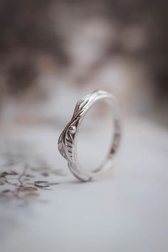 a silver ring with an intricate design on it