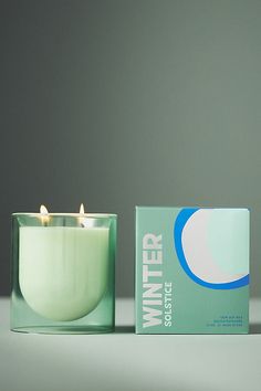 a candle that is sitting next to a box