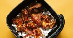 some chicken wings are in a black container