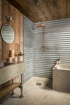 a bathroom with a sink, mirror and bathtub in the corner next to a corrugated wall