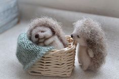 two small stuffed hedges in a basket