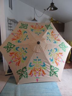 an open umbrella sitting on top of a rug