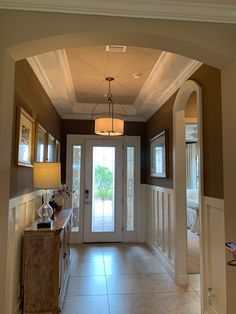 an entry way leading to a bedroom and another room with a door that is open