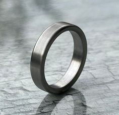 5mm Flat Natural Titanium Minimalist Ring  Why choose titanium rather than silver or gold? titanium requires zero maintenance, wear it day and night, expose it to all liquids, wear it at work. This ring will last forever. titanium is an extremely hard wearing metal and is very difficult to scratch. Medically Titanium is preferred as a hypoallergenic material as it contains no lead or Nickle. * Material: Titanium. * Colors: Silver. * Packaging: Complimentary Box. * Processing Time: Each Item Is Handmade With Love As We Receive Orders. Our Production Time Is 1 To 2 Week. We Will Ship As Soon As Your Item Is Ready. The Titanium Ring boasts a sleek and modern design, featuring a seamless band that effortlessly encircles your finger. The minimalist aesthetic ensures that it can be worn with cas Titanium Raised Stone Engagement Ring, Brushed Titanium Women Engagement Ring, Round Minimalist Titanium Jewelry, Minimalist Round Titanium Jewelry, Minimalist Rings With Brushed Finish For Anniversary, Minimalist Brushed Finish Promise Ring, Silver Titanium Ring With Brushed Finish, Minimalist Titanium Jewelry For Anniversary, Titanium Ring With Brushed Finish For Gift