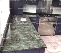 a kitchen with granite counter tops and stainless steel appliances