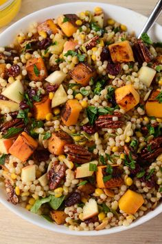 a white bowl filled with corn and vegetables