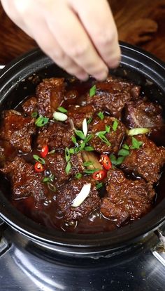 a person is stirring some food in a pan