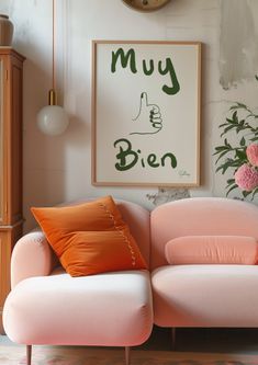 a pink couch sitting in front of a clock