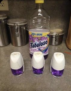 three bottles of fabuloso are sitting on the counter next to some containers