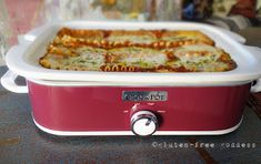 a red and white casserole dish sitting on top of a table