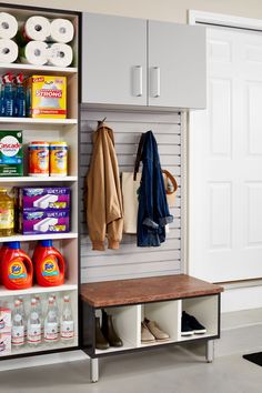 an organized storage area with white cabinets and shelves filled with cleaning products, toiletries and other household items