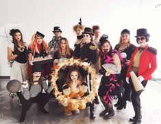 a group of people dressed in costumes posing for a photo