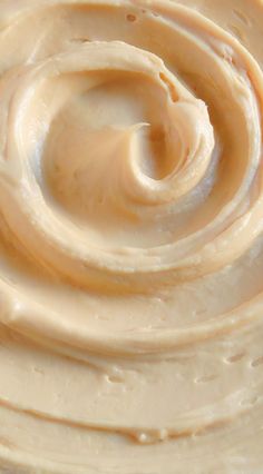 a close up view of the inside of a jar of peanut butter with swirls in it