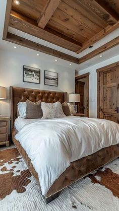 a large bed sitting in the middle of a bedroom next to a wooden door and window