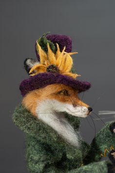 a needled fox wearing a hat and holding a flower in it's mouth