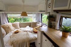 the interior of a camper is clean and ready to be used as a bed